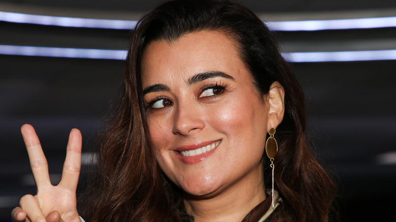 Cote de Pablo giving peace sign