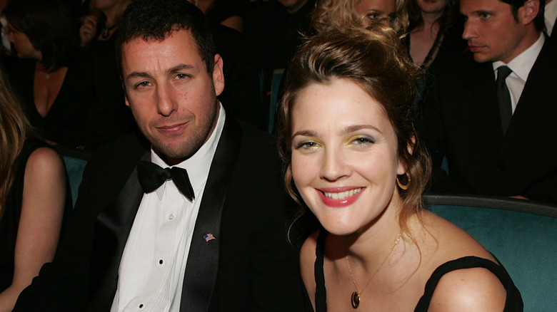 Adam Sandler and Drew Barrymore sitting together