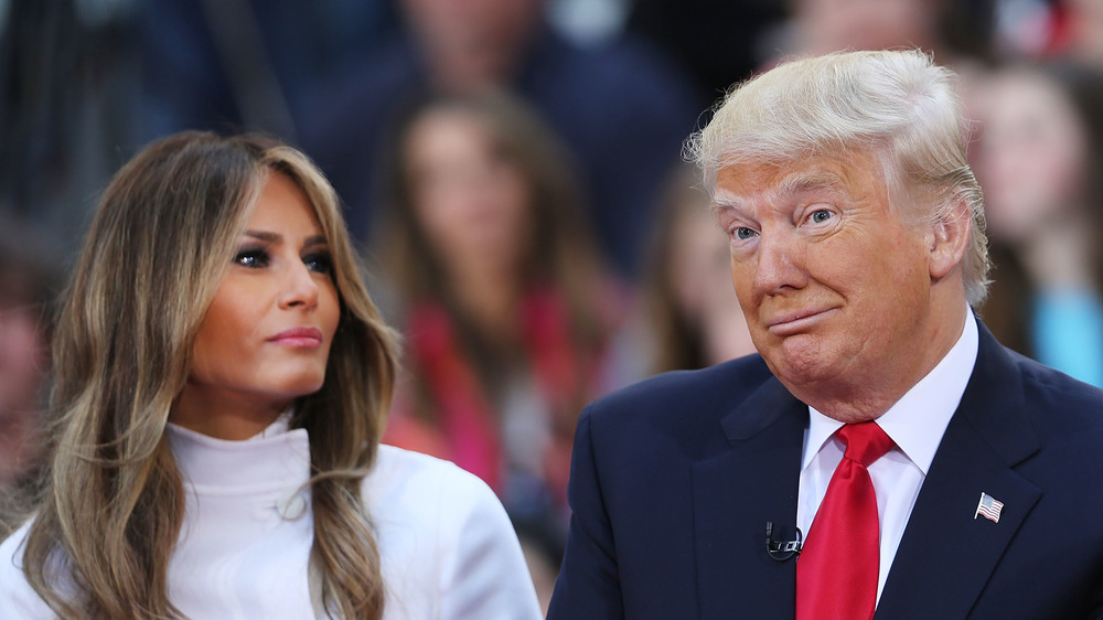 Melania Trump looking at a shrugging Donald Trump