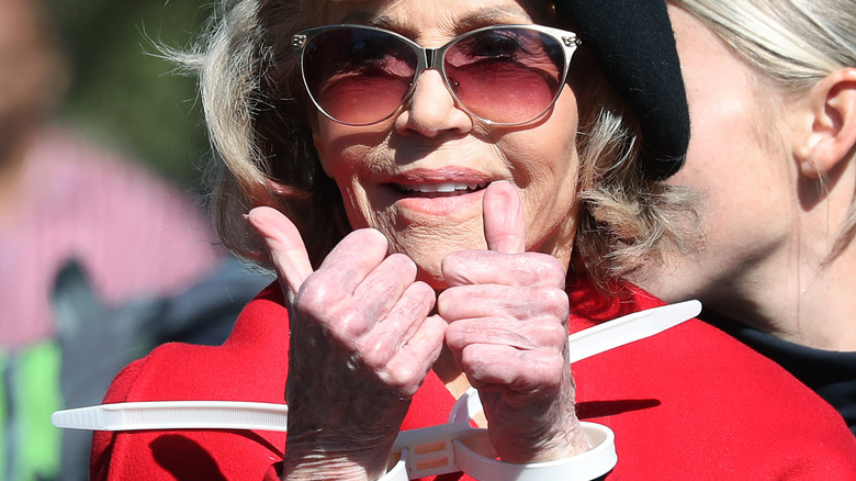 Jane Fonda in plastic cuff ties