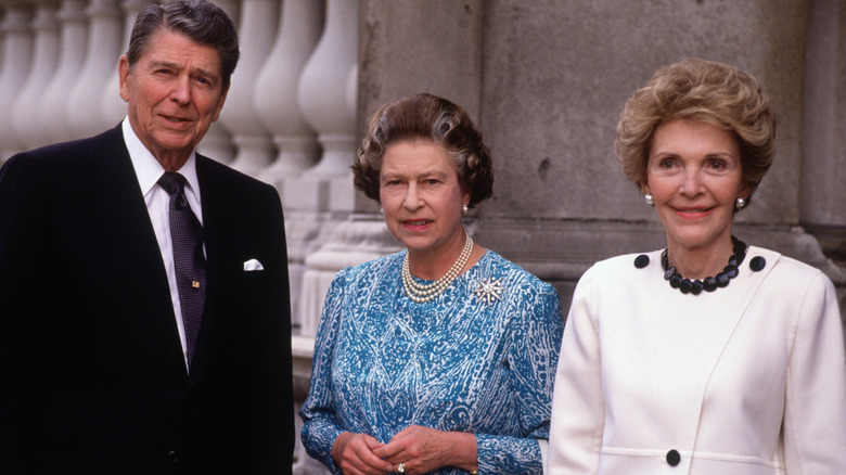 Queen Elizabeth II posing with Ronald and Nancy Reagan 