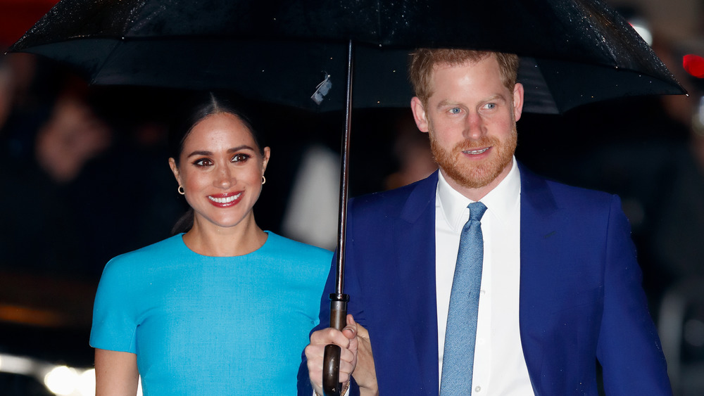 Prince Harry and Meghan Markle with umbrella