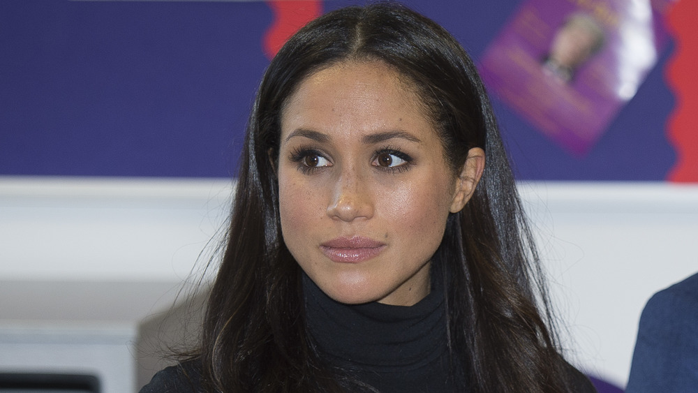 Meghan Markle staring intently 