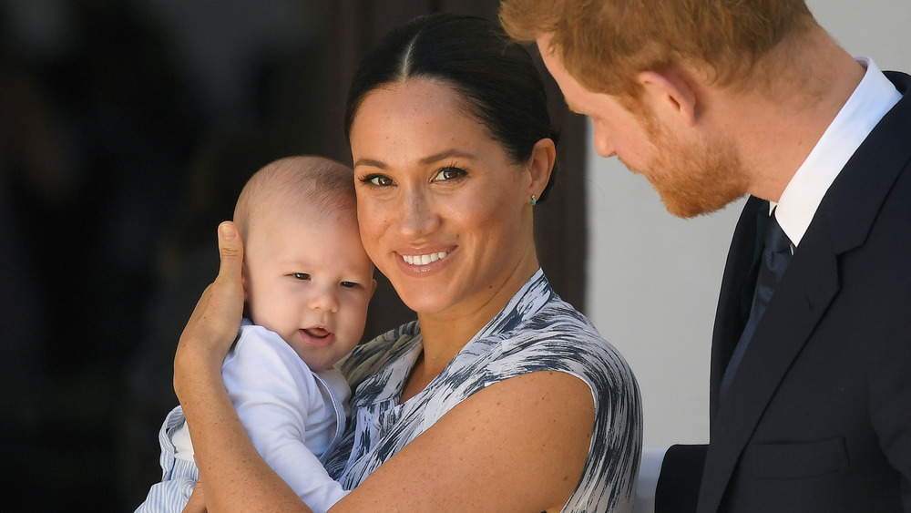 Meghan Markle holding Archie with Prince Harry