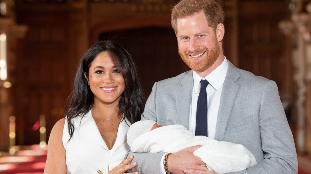 Meghan Markle and Prince Harry holding Archie