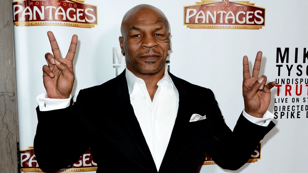 Mike Tyson throwing up peace signs