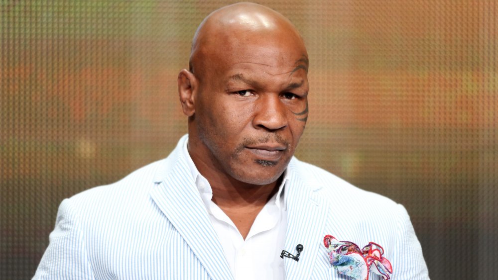 Mike Tyson in a white and blue striped blazer