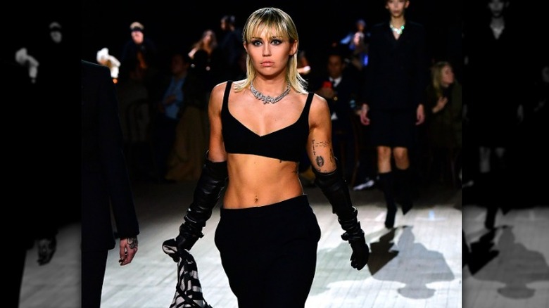 Miley Cyrus in black walking runway