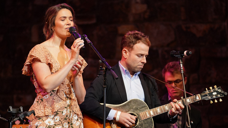 Mandy Moore and Taylor Goldsmith performing onstage 