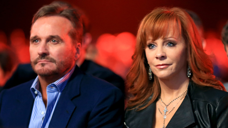 Reba McEntire and Narvel Blackstock staring