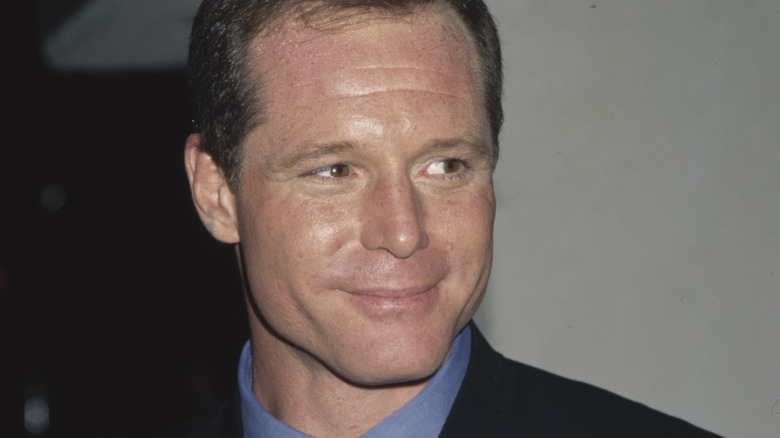 Younger Jason Beghe smiling