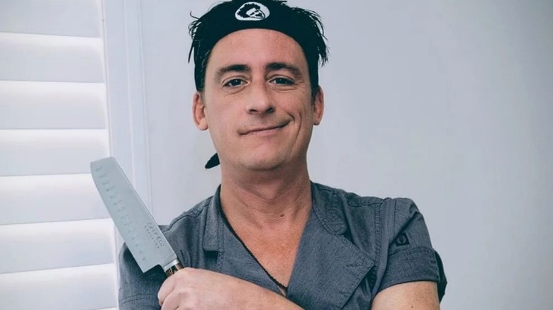 Below Deck Chef Ben Robinson holding knife