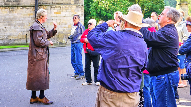 A tour guide gives a tour at Holyroodhouse