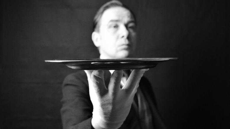 A butler holding a tray