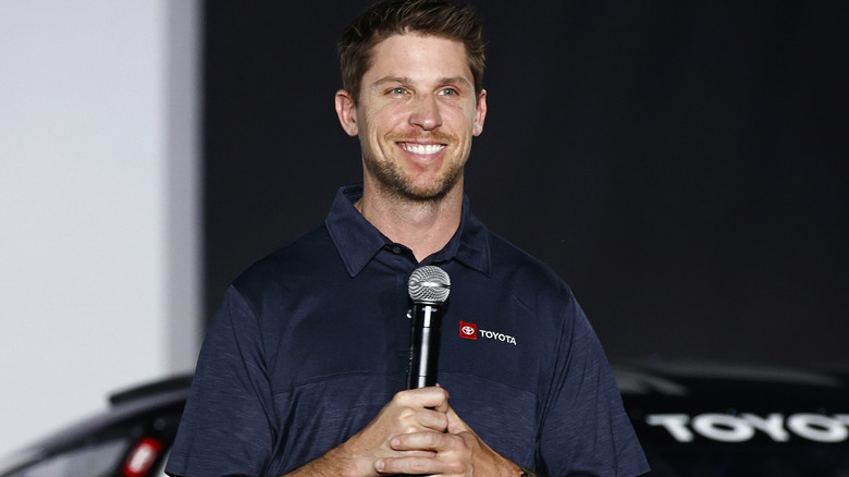 Denny Hamlin smiling at new NASCAR unveiling