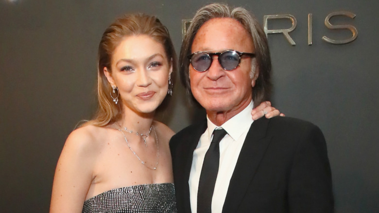 Gigi Hadid smiling with her arm around dad Mohamed Hadid's shoulder