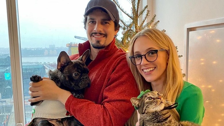 Kat Timpf and Cameron Friscia holding cats