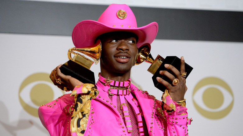 Lil Nas X holding his Grammy awards