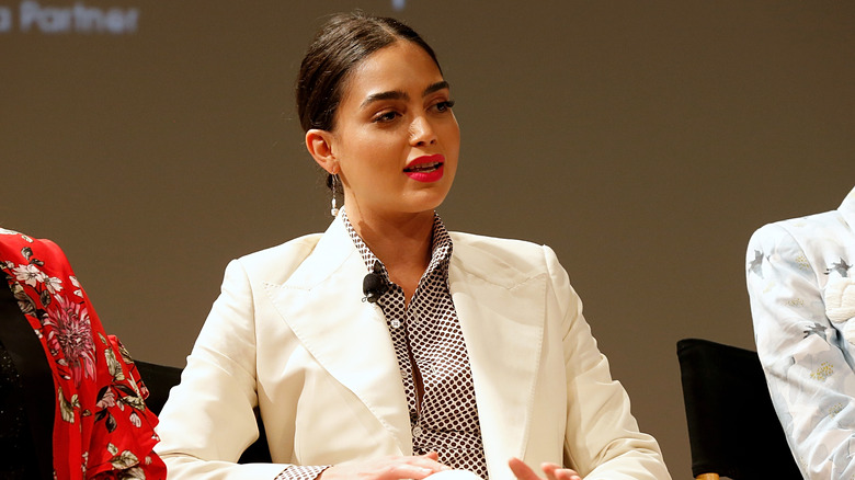 Melissa Barrera, talking, looking serious, wearing a white pant suit, 2019 Tribeca Film Festival
