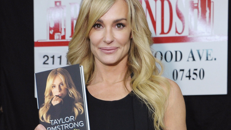 Taylor Armstrong holding her book