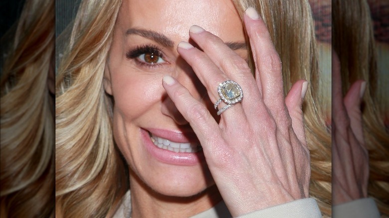 Taylor Armstrong with ring, covering her face, smiling