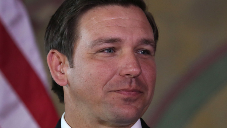 Ron DeSantis smirks at an event