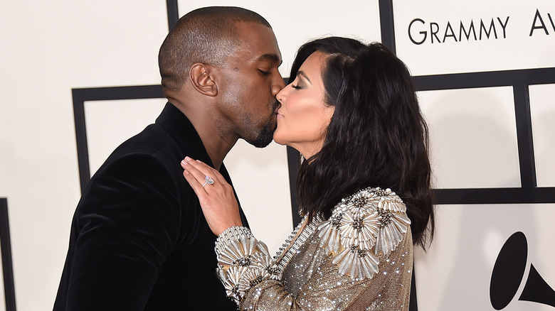 Kanye West and Kim Kardashian kissing on the red carpet