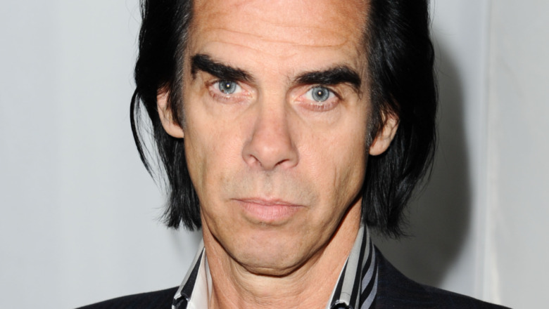 Nick Cave staring straight at camera with serious expression