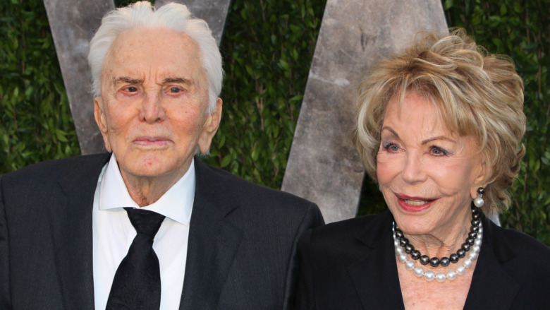 Kirk Douglas and Anne Douglas posing on red carpet