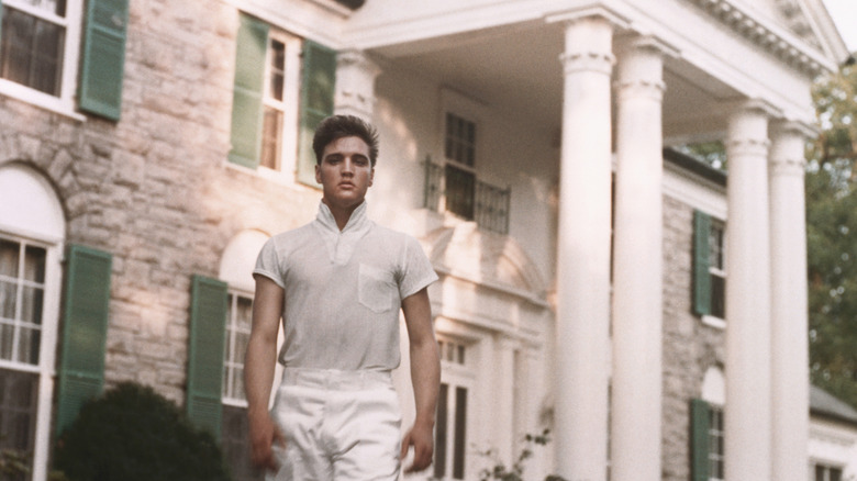 Elvis Presley stood outside Graceland