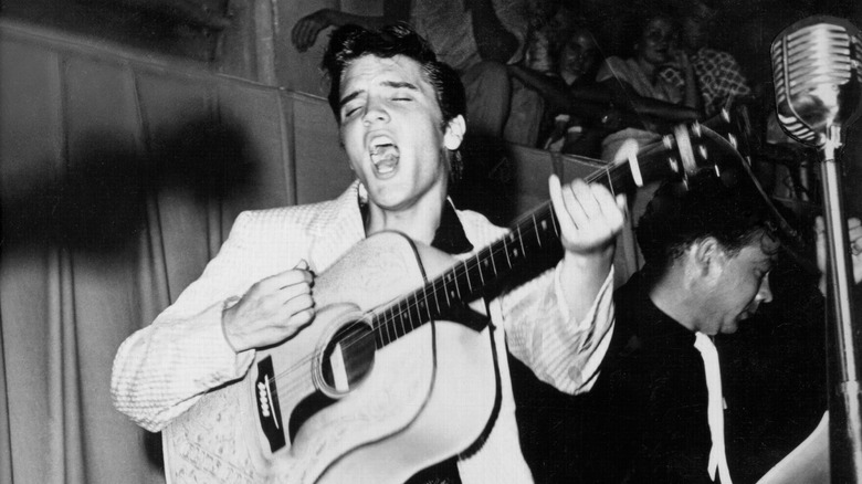 Elvis Presley playing the guitar