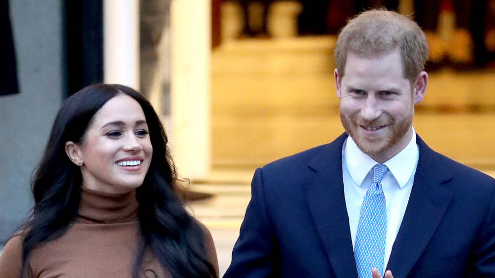 Meghan Markle and Prince Harry smiling at the crowd