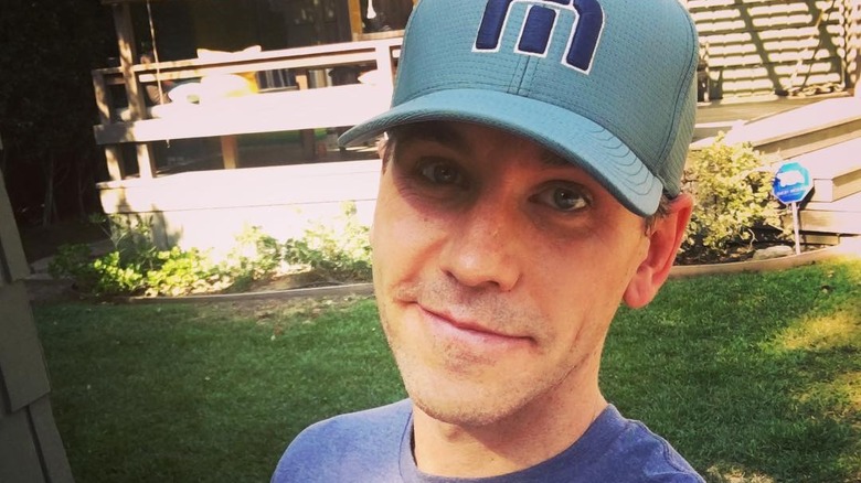 Brian Dietzen poses in a hat