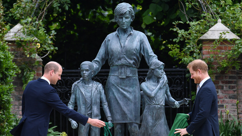 Princes William and Harry unveil a statue to honor Princess Diana.