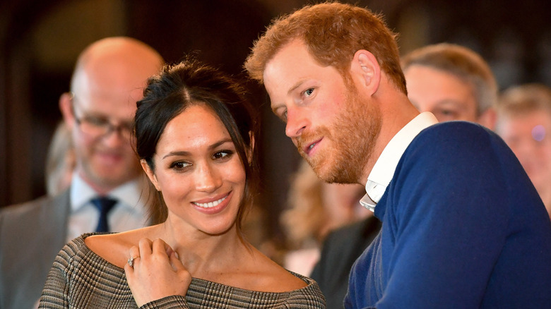 Prince Harry speaking to Meghan Markle