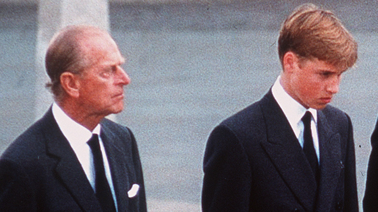 Prince Philip walking next to Prince William at Princess Diana's funeral