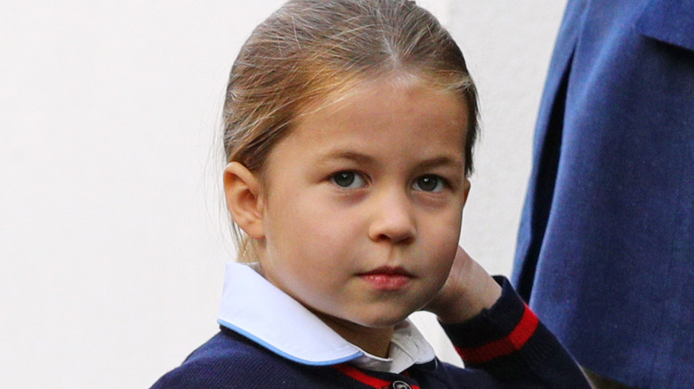 Princess Charlotte touching her hair and looking up