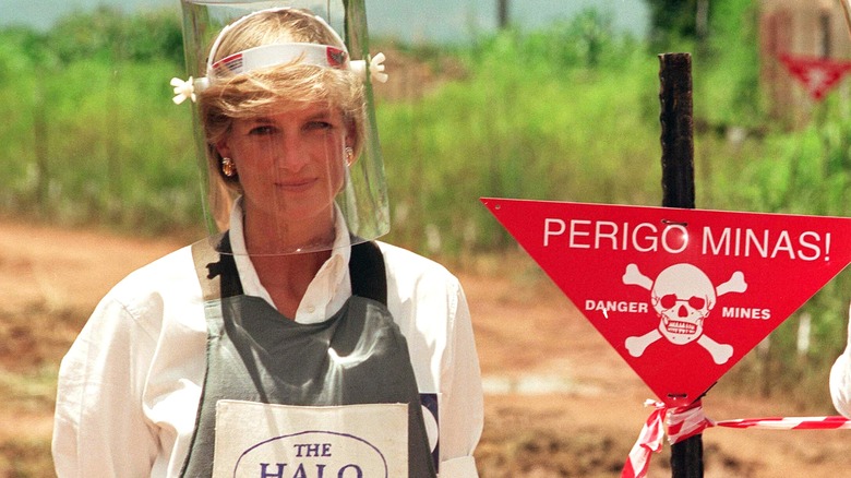 Princess Diana in protective gear on a minefield in Angola.