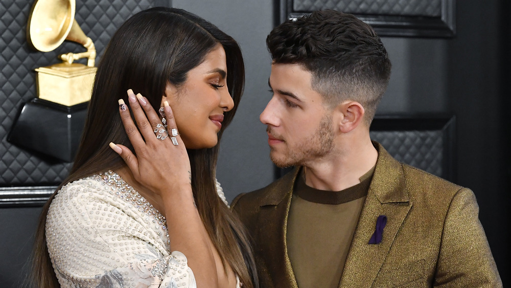 Priyanka Chopra smiling at Nick Jonas while he looks into her eyes