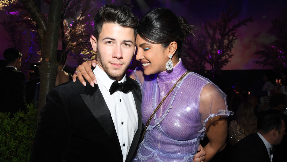 Nick Jonas and Priyanka Chopra lovingly embrace at an event