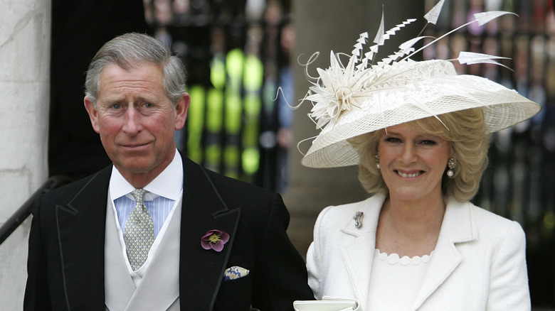 King Charles slicked back hair Queen Camilla large white hat