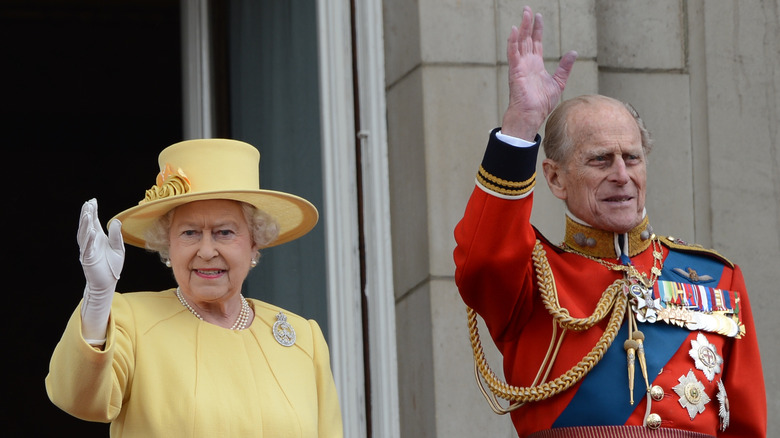 Queen Elizabeth and Prince Philip waving