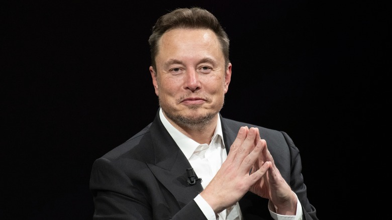 Elon Musk with his hands together