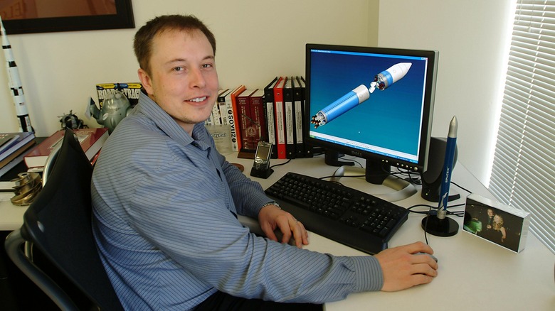 Elon Musk in front of a computer