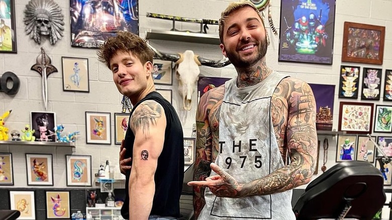 Matt Rife posing with tattoo artist