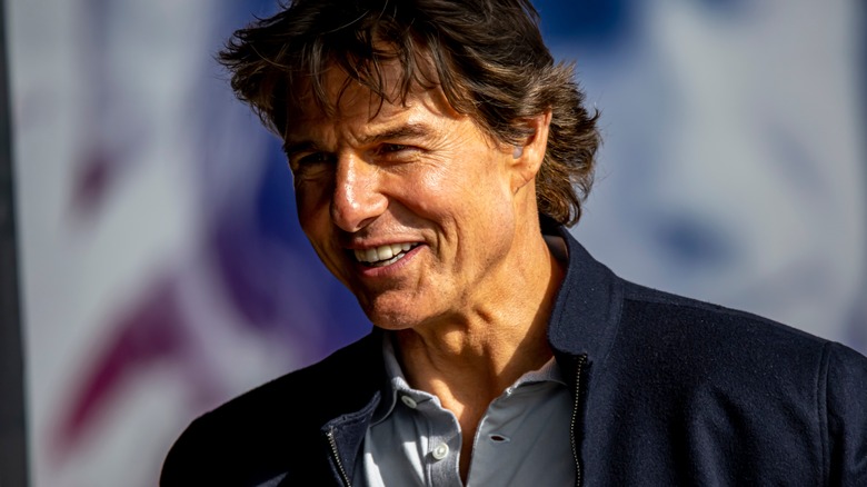 Tom Cruise smiling in blue jacket