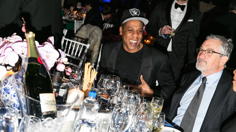 Jay-Z and Robert De Niro smiling at the amFAR gala