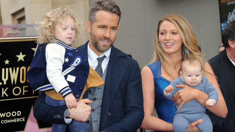 Ryan Reynolds and Blake Lively posing with two of their daughters