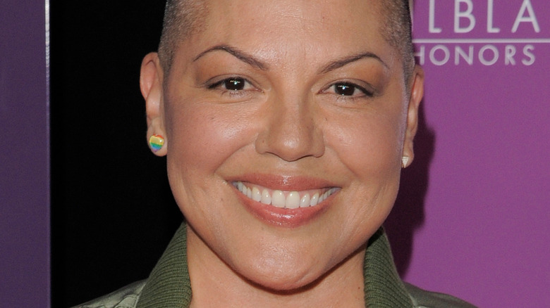 Sara Ramirez smiling pride earrings