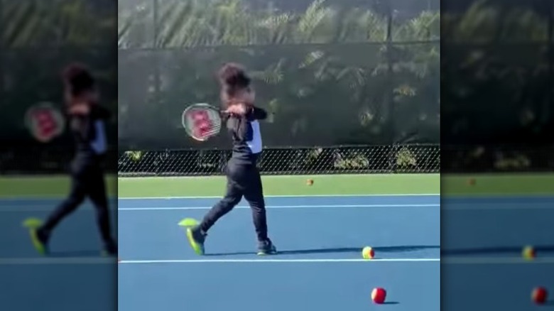 Olympia hitting tennis balls